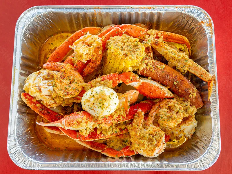 Crispy whole fried red snapper with fresh lemon wedges at This is Seafood, a Seafood Restaurant in District Heights