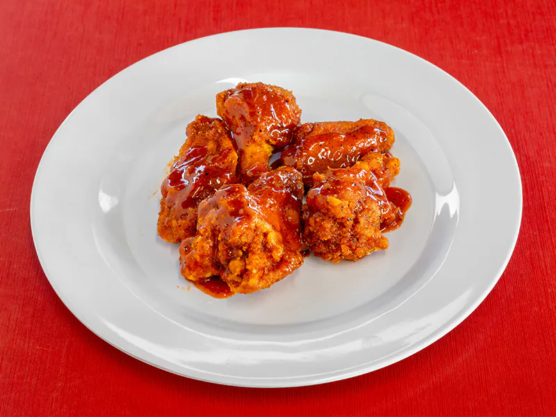 Crispy chicken wings coated in a sweet and spicy sticky glaze at This is Seafood, a Seafood Restaurant in District Heights
